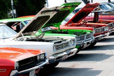 close-up shot of Row of muscle cars at car show