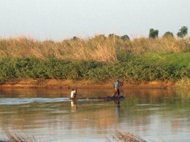 African fishermen on wooden boat