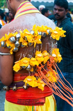 Devotee with hanging milk pots