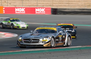 racing speed cars at 24 Hour Race at Dubai Autodrome on January 14, 2012 clipart