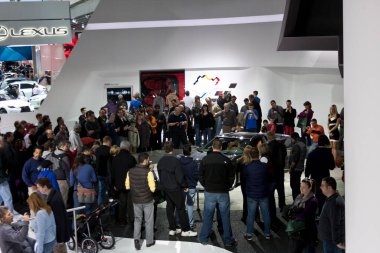 DETROIT - JANUARY 27 :The crowd gathering around the new 2014 Chevrolet Corvette stringray C7 at The North American International Auto Show January 27, 2013 in Detroit, Michigan.
