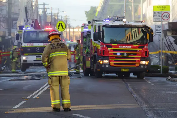Firefighters and rescue crew attend shop blast