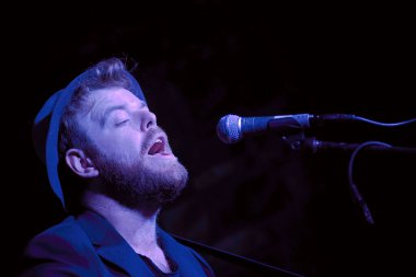 singer with beard and microphone