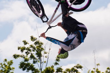 Acrobat man jumping on bicycle