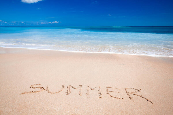 Summer text on sandy beach