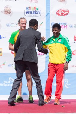 Addis Ababa, Etiyopya 24 Kasım: Dünyaca ünlü atlet Haile Gebrselassie, 24 Kasım 2013 'te Etiyopya' nın Addis Ababa kentinde düzenlenen 13. Büyük Etiyopya Seferi 'nde uzun mesafe koşucusu Gebremariam Gebregziabiher' i sahnede karşıladı..
