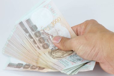 stack of Thai money banknotes in hand