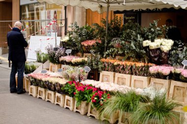 man looking at flowers in flower shop