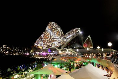 Sydney Opera House with multicolor illuminated projection at night, famous Australian architecture  clipart