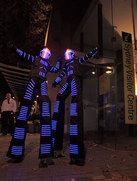 Illuminated street performers,  stilt walkers for Sydney Visitor Center