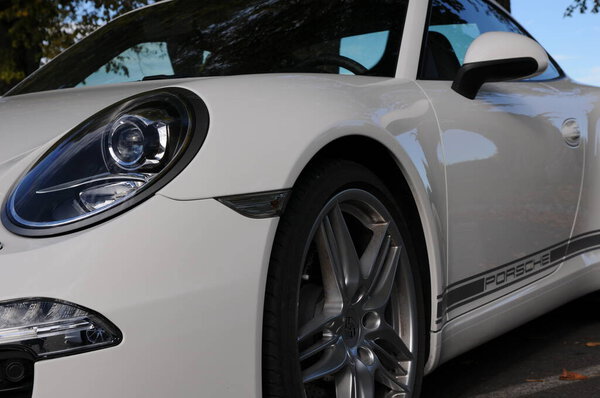 White porsche carrera on the street 