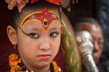 NEPAL, Patan: A young girl attends the Bunga Dyah Jatra chariot festival in Patan, Nepal on September 26, 2015, drawing thousands of devotees to honor the Buddhist deity of compassion Avalokitesvara. 