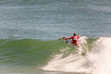 Professional female surfer compete on the Burleigh Pro 2013