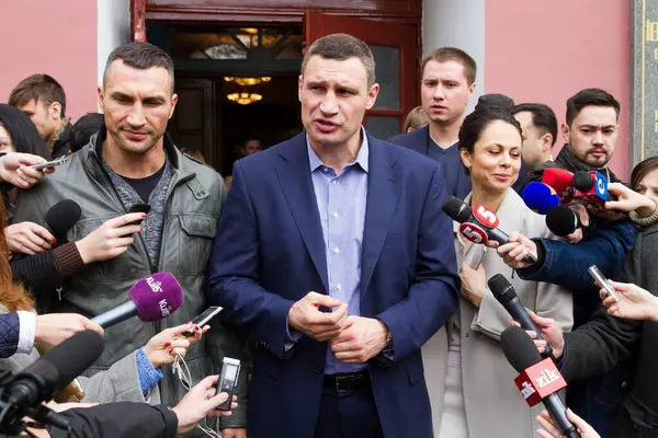 Stock image UKRAINE, Kiev: Kiev's mayor Vitaly Klitschko, his wife Natalia, and brother Vladimir Klitschko prepare to cast their ballots at a polling station in Kiev on October 25, 2015.