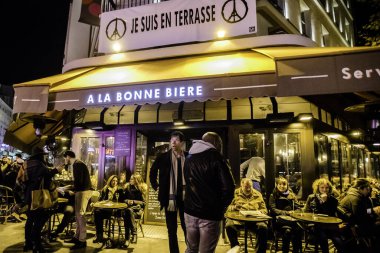 FRANCE, Paris: People on the terrace of the bar A la Bonne Biere in Paris on December 4, 2015, during its reopening day after it was hit during a series of coordinated attacks in and around Paris on November 13.       clipart