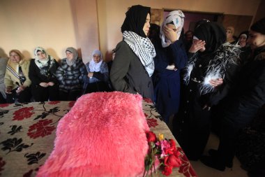 WEST BANK, Qalandia: Hadeel Awwad's familly mourn around the body of the 14-year-old Palestinian girl, who was shot dead on November 23 by an Israeli police officer following a stabbing attack in Jerusalem's central market