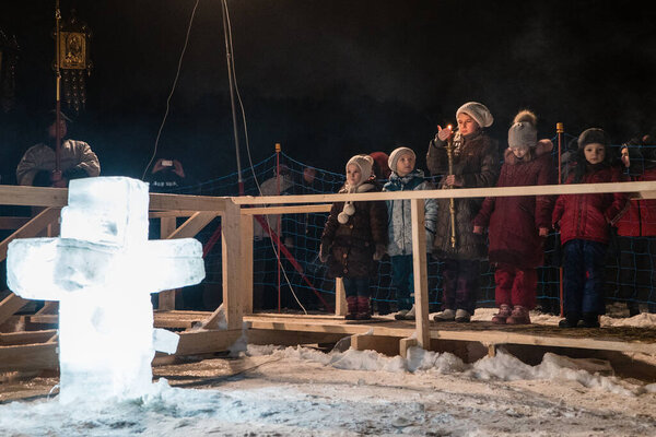 RUSSIA, Moscow: Children stand and watch Epiphany ceremonies on January 19, 2016 in Moscow, Russia.
