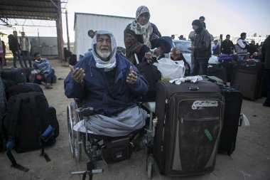 GAZA STRIP, Rafah: Palestinians await permission to enter Egypt as they gather at the Rafah border crossing in the southern Gaza Strip on February 14, 2016.  clipart