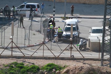 WARNING: GRAPHIC CONTENTWEST BANK: Israeli defense forces stand at the scene, where a Palestinian man was killed on February 14, 2016, in the occupied West Bank near Har Homa.