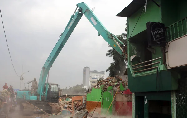 stock image INDONESIA, Jakarta: A worker demolishes houses of the Kalijodo red light district, in the Penjaringan subdistrict on the border of North and West Jakarta, on February 29, 2016.