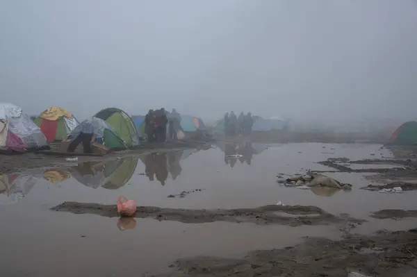 stock image GREECE, Idomeni: Refugees gather on the railroad tracks at the Greek-Macedonian border near the Greek village of Idomeni, where thousands of refugees and migrants are trapped by the Balkan border blockade, on March 9, 2016