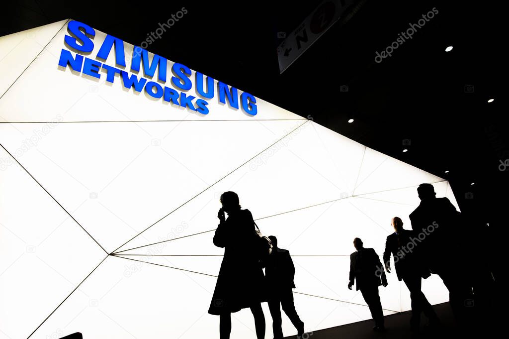 SPAIN, Barcelona: Visitors are seen walking in front of the Korean multinational conglomerate corporation Samsung Networks' stand during the Mobile World Congress, in Barcelona, on February 22, 2016.