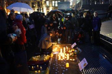 UNITED KINGDOM, London : A man lights a candle during a tribute to the victims of the Brussels terror attacks, in Trafalgar Square in central London on March 24, 2016.