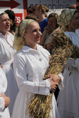 People in Croatian national costumes during festival in Dakovo clipart