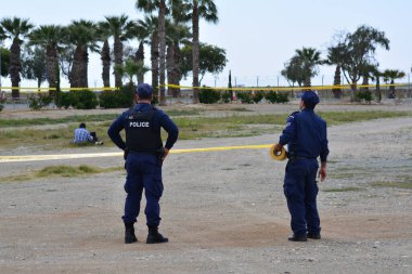 CYPRUS, Larnaca : Cypriot policemen stand guard in the vicinity of Larnaca airport where an EgyptAir Airbus A-320 (C) sits on the tarmac after being hijacked and diverted to Cyprus on March 29, 2016.