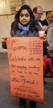 UK, London: A woman holds a sign during a candlelight vigil at the Pakistan High Commission in London on March 29, 2016. 