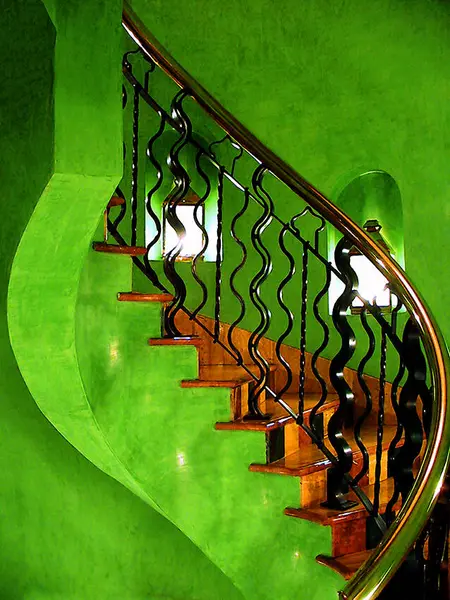 green staircase with metal railing