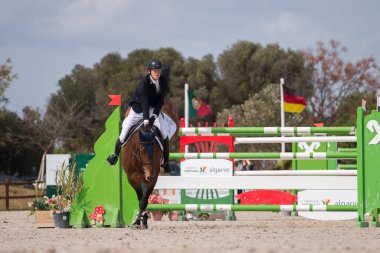 VILAMOURA, PORTUGAL - APRIL 3, 2016: Horse obstacle jumping competition