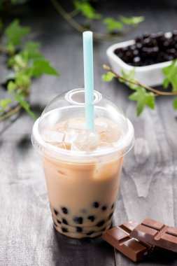 Homemade chocolate milk bubble tea in plastic cups on table