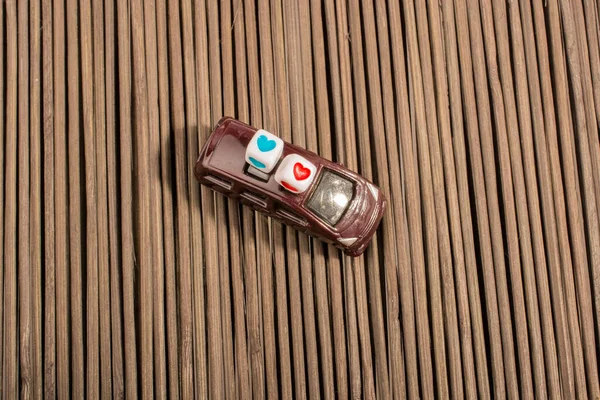 toy car and beads on a straw mat