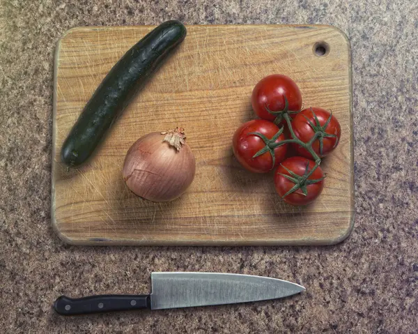 Vegetables on cutting board with knife