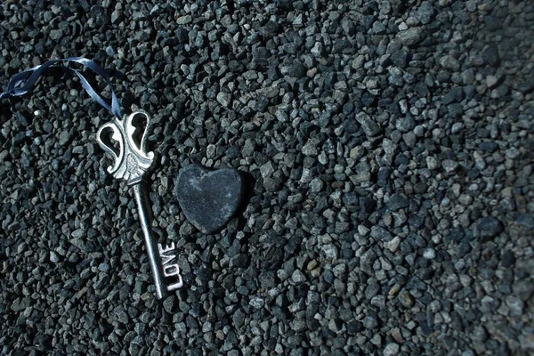 key and heart on stones