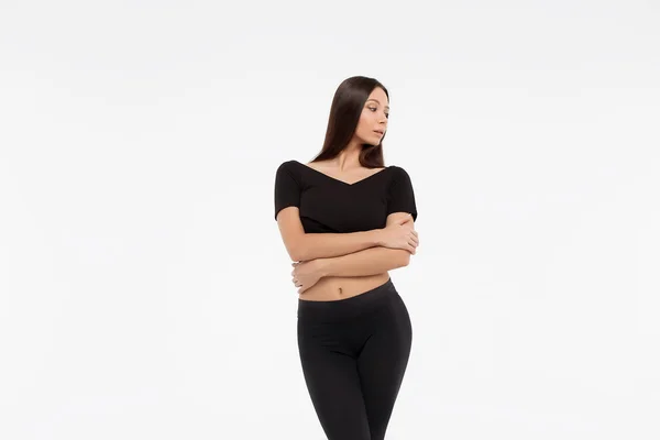 stock image Caucasian brunette woman in black clothes posing against white background