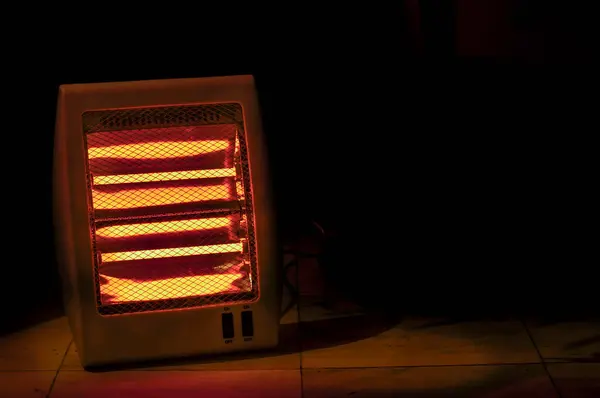 Electric heater on black background