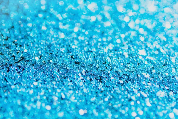 Defocused blue glitter background. blue abstract bokeh background