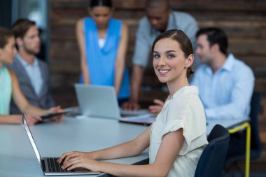 İş yürütme masaya oturan ve dizüstü bilgisayar kullanma office