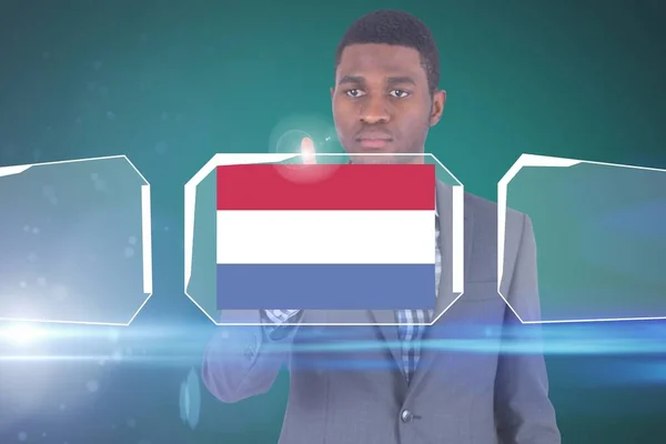 Businessman pointing on Dutch flag hologram