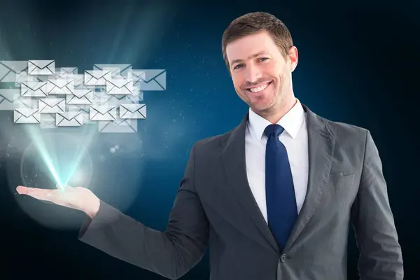 Businessman holding email hologram