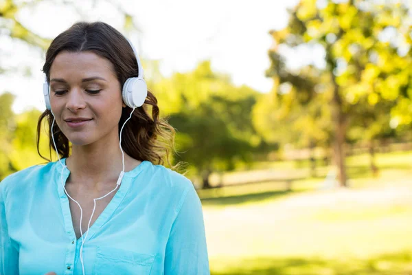 stock image Woman listening music in headphones