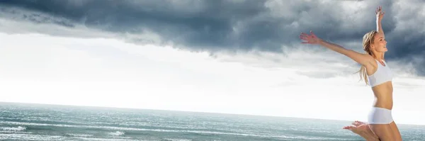 下着の若い女性は灰色のビーチでジャンプ — ストック写真