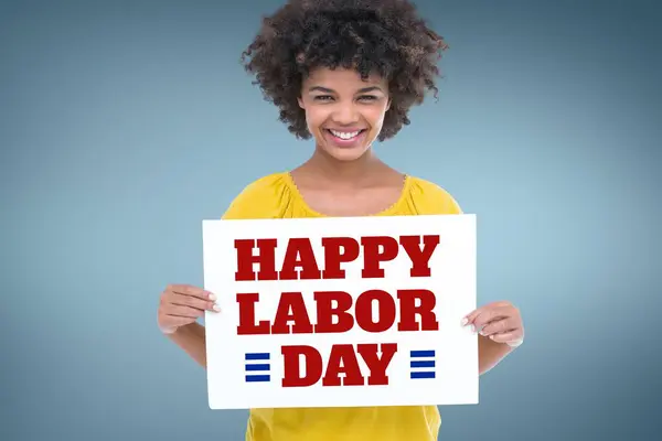 Happy woman holding a Labor Day card against blue background