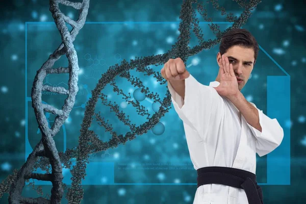 Man doing martial arts with 3D DNA strands against blue background
