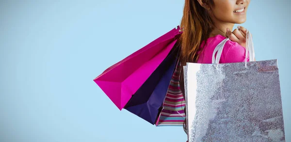 ショッピングバッグと笑顔のアジア女性の複合画像 — ストック写真
