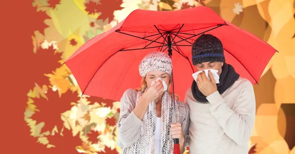 Autumn leaves and sick couple with flu under umbrella