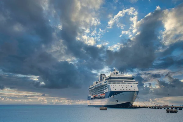 Niebiesko Biały Statek Wycieczkowy Zadokowany Pod Dramatycznym Niebem — Zdjęcie stockowe