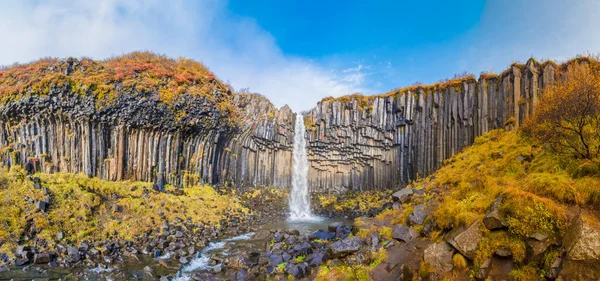 秋色风景间黑色玄武岩柱的Svartifoss瀑布全景 — 图库照片